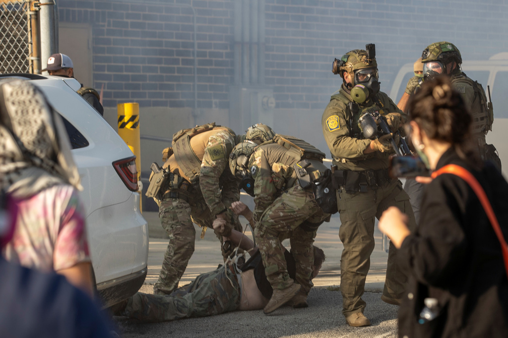 FILE - Immigration and Customs Enforcement officers arrest a protester at the ICE facility in Broadview, Ill., Sept. 19, 2025. (Zubaer Khan /Chicago Sun-Times via AP, File)