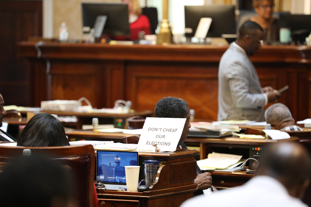 A sign sits on the desk of Democratic South Carolina Rep. Annie McDaniel during the House redistricting debate on Tuesday, May 19, 2026, in Columbia, S.C. (AP Photo/Jeffrey Collins)