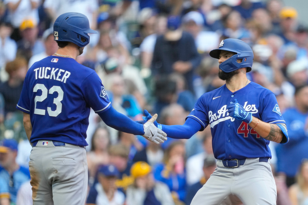 Los Angeles Dodgers' Kyle Tucker (23) greets teammate Andy Pages (44) after Pages hit a two-run home run during the fifth inning of a baseball game against the Milwaukee Brewers, Sunday, May 24, 2026, in Milwaukee. (AP Photo/Kayla Wolf)