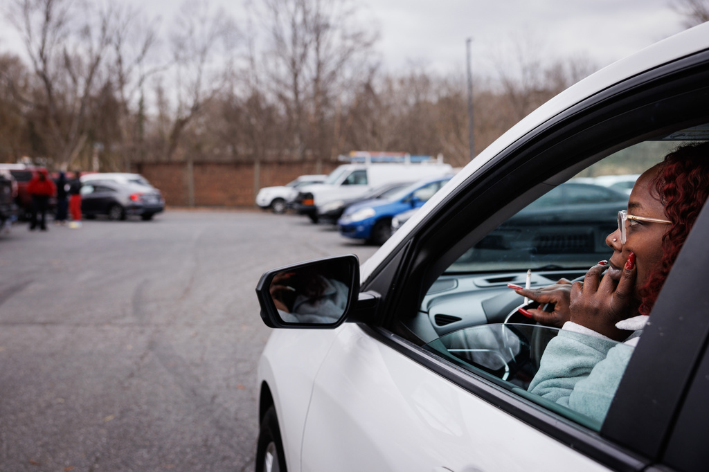 Stephanie Leecost, a mother of a North Forsyth High School junior, watches and waits from her car in a parking lot across the street after a fatal stabbing, Tuesday, Dec. 9, 2025, in Winston-Salem, N.C. (Allison Lee Isley/The Winston-Salem Journal via AP)