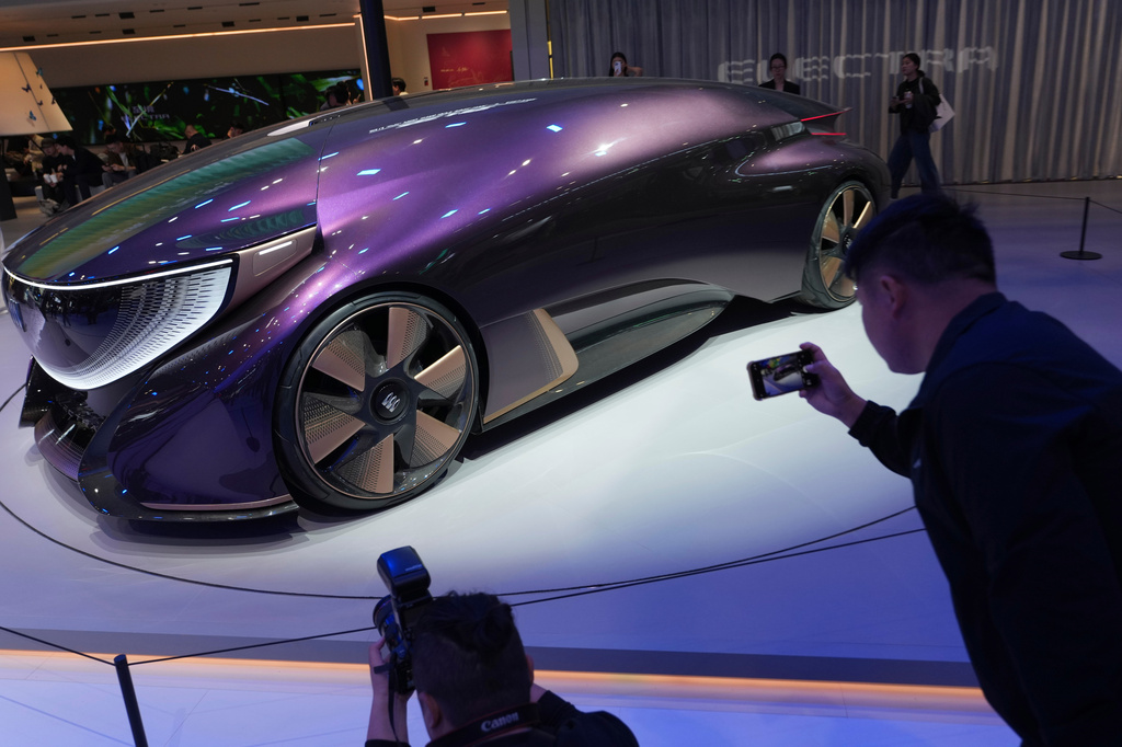 Attendees look at a concept vehicle from Buick during Auto China 2026 in Beijing, Friday, April 24, 2026. (AP Photo/Ng Han Guan)