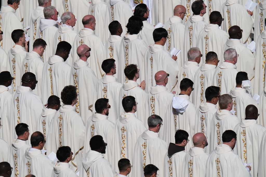 Clergy follow Pope Leo XIV as he presides over Easter Mass in St. Peter's Square at the Vatican, Sunday, April 5, 2026. (AP Photo/Alessandra Tarantino)