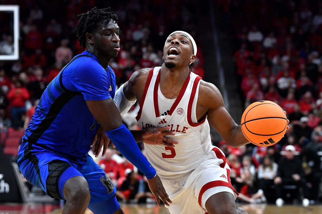 Louisville guard Ryan Conwell (3) attempts to drive past Memphis guard Hasan Abdul Hakim (14) during the second half of an NCAA college basketball game in Louisville, Ky., Saturday, Dec. 13, 2025. (AP Photo/Timothy D. Easley)