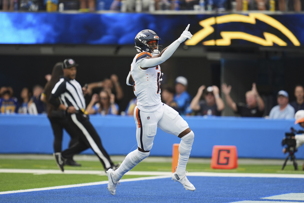 Denver Broncos wide receiver Courtland Sutton (14) scores a touchdown during the first half an NFL football game against the Los Angeles Chargers, Sunday, Sept. 21, 2025, in Inglewood, Calif. (AP Photo/Gregory Bull)
