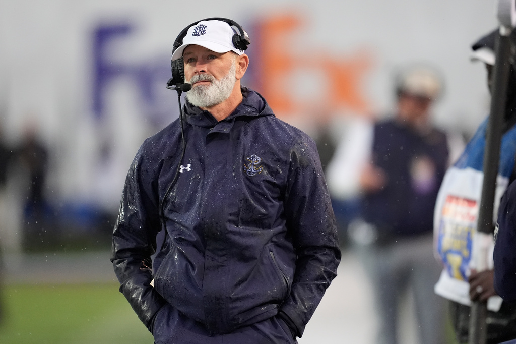 FILE - Navy head coach Brian Newberry looks onto the field from the sideline during the first half of the Liberty Bowl NCAA college football game against Cincinnati, Jan. 2, 2026, in Memphis, Tenn. (AP Photo/George Walker IV, File)