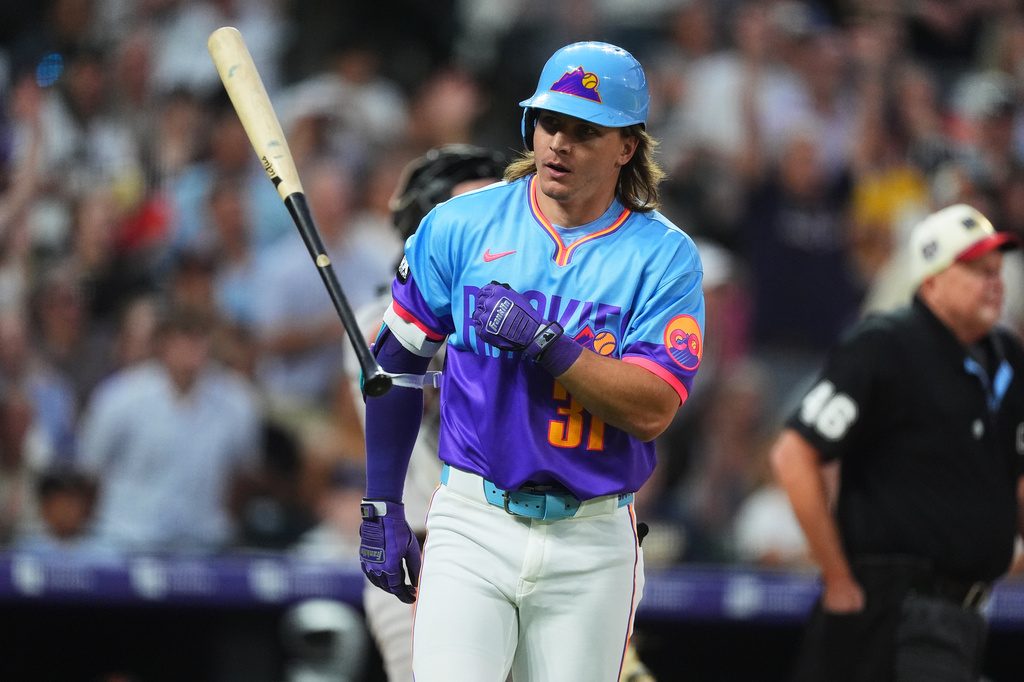 Colorado Rockies' Jake McCarthy tosses his bat as he heads up the first-base line after hitting a grand slam off San Francisco Giants relief pitcher Matt Gage in the fifth inning of a baseball game Friday, July 3, 2026, in Denver. (AP Photo/David Zalubowski)