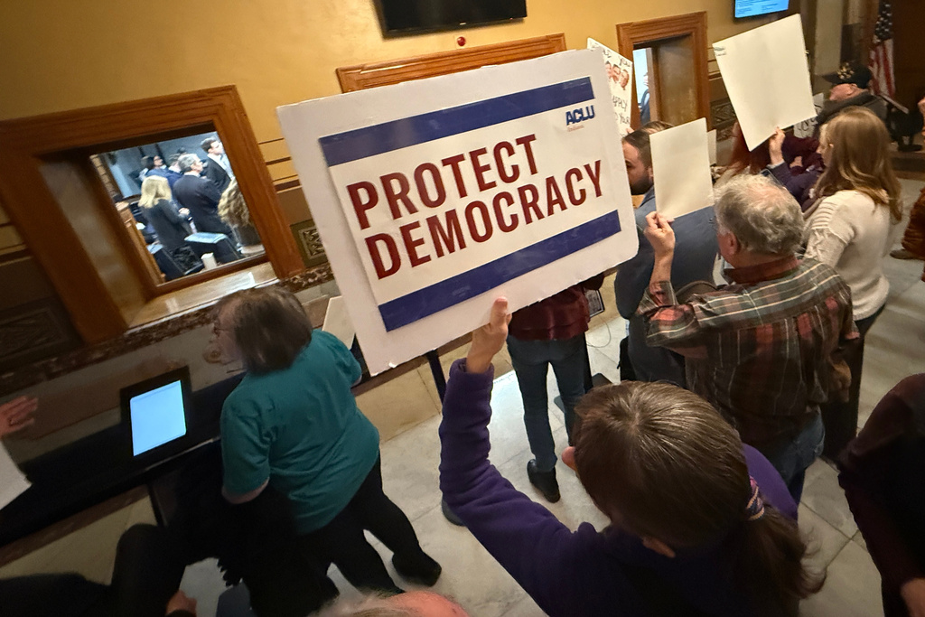 Protesters gather outside the Senate chamber at the Statehouse as senators meet during a special session to vote on a new congressional map Monday, Dec. 8, 2025, in Indianapolis. (AP Photo/Obed Lamy)