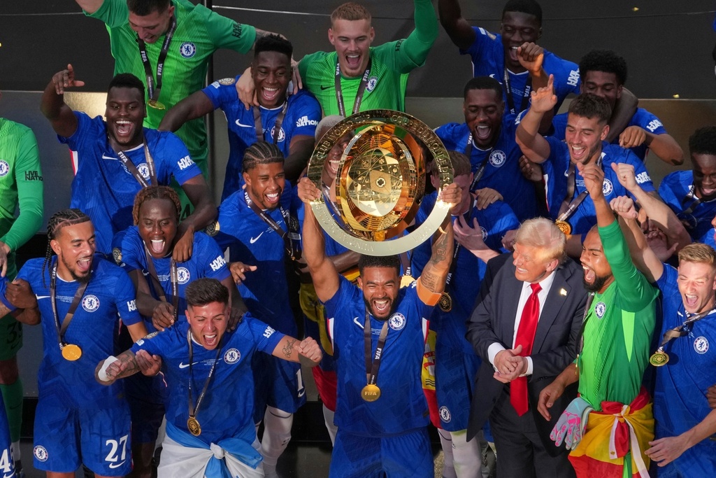 FILE - Chelsea pleayers celebrate with the championship trophy after the Club World Cup final soccer match between Chelsea and PSG in East Rutherford, N.J., Sunday, July 13, 2025. (AP Photo/Matt Slocum, File)