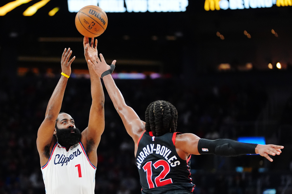 Los Angeles Clippers' James Harden (1) shoots over Toronto Raptors' Collin Murray-Boyles (12) during the first half of an NBA basketball game in Toronto, Friday, Jan. 16, 2026. (Frank Gunn/The Canadian Press via AP)