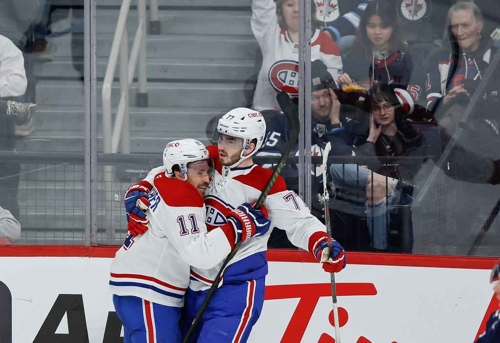 Montreal Canadiens' Brendan Gallagher (11) and Kirby Dach (77) celebrate Gallagher's goal against the Winnipeg Jets during the third period of an NHL hockey game, in Winnipeg, Manitoba, Wednesday, Feb. 4, 2026. (John Woods/The Canadian Press via AP)
