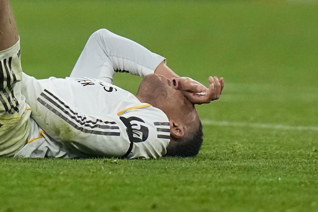 Real Madrid's Kylian Mbappe lies on the pitch after injuring during the Champions League quarterfinal second leg soccer match between Bayern Munich and Real Madrid in Munich, Germany, Wednesday, April 15, 2026. (AP Photo/Matthias Schrader)