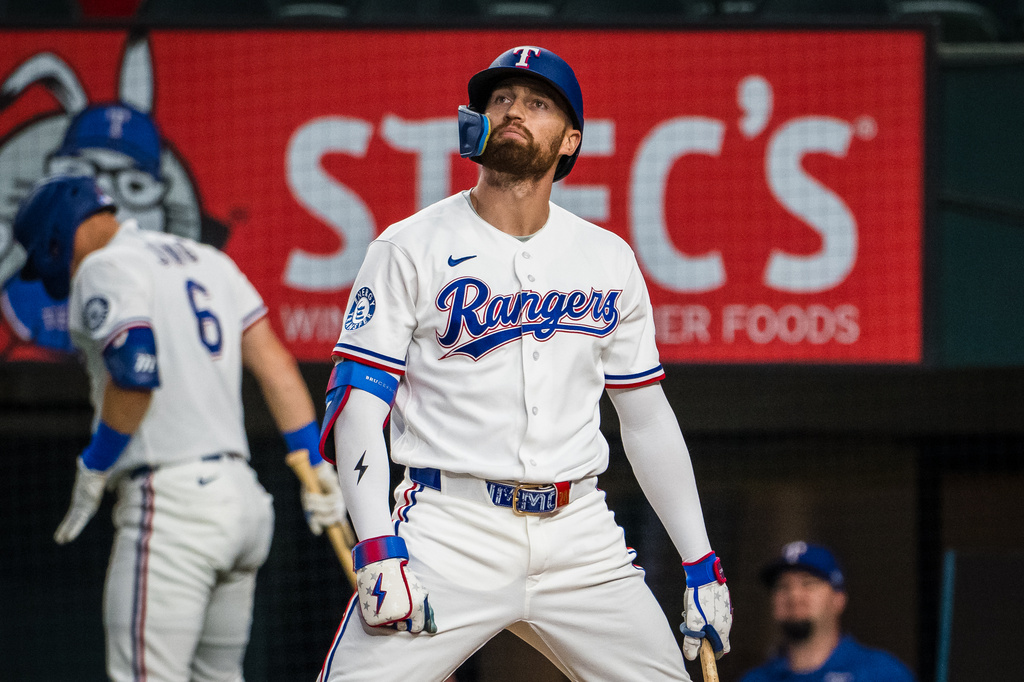 Texas Rangers' Brandon Nimmo reacts during the first inning of a baseball game against the Houston Astros, Tuesday, May 26, 2026, Arlington, Texas. (AP Photo/Jessica Tobias)