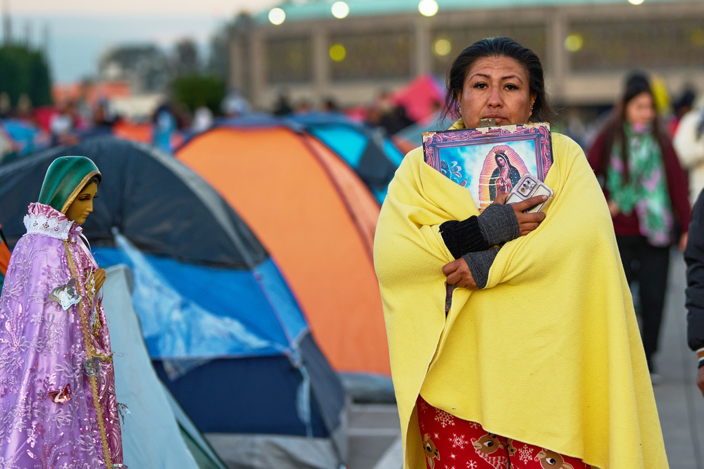 Pilgrims arrive to Our Lady of Guadalupe Basilica in Mexico City, Thursday, Dec. 11, 2025, the day before her feast day. (AP Photo/Claudia Rosel)