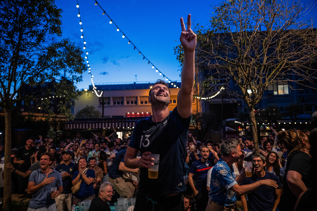 French fans react as they watch a broadcast of the World Cup Group I soccer match between France and Senegal, Tuesday, June 16, 2026, in Paris. (AP Photo/Aurelien Morissard)