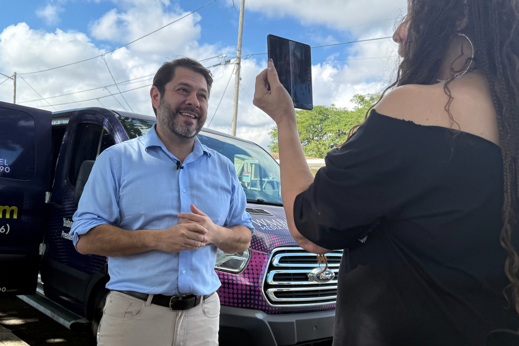 Senator Ruben Gallego, has his photo taken while he campaigns with Eileen Higgins during her campaign for Miami Mayor on Sunday, Dec. 7, 2025 in Miami. (AP Photo/Adriana Gomez)