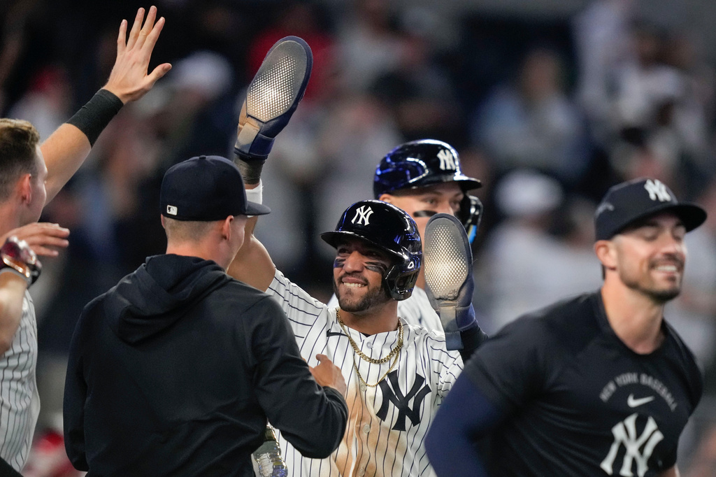 New York Yankees' José Caballero, center, celebrates with teammates after scoring during the ninth inning of a baseball game against the Los Angeles Angels, Monday, April 13, 2026, in New York. (AP Photo/Yuki Iwamura)