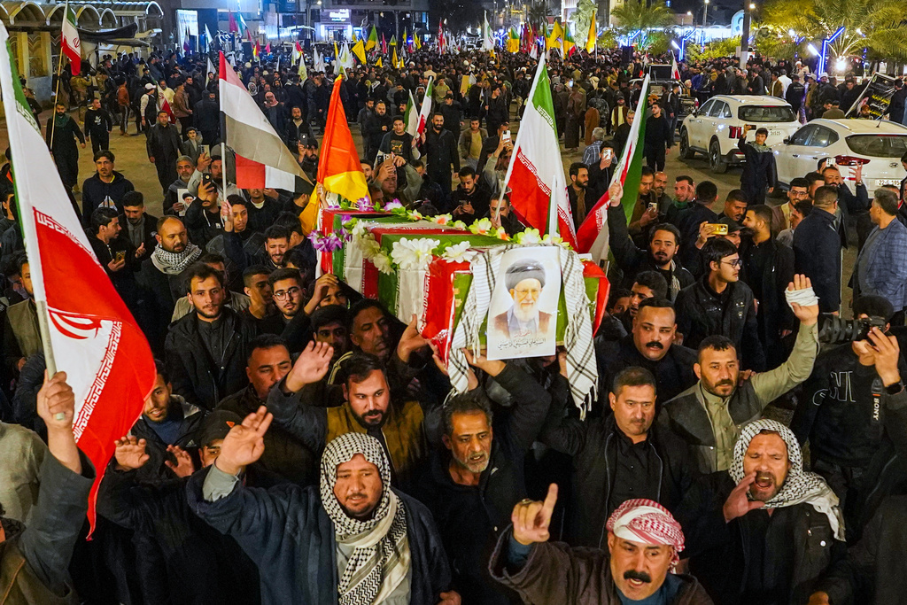 Iraqi Shiite carry a mock coffin of Iranian supreme Leader Ayatollah Ali Khamenei, who was killed by a U.S. airstrike in Tehran, during a symbolic funeral, in Najaf, Iraq, Sunday, March 1, 2026. (AP Photo/Anmar Khalil)