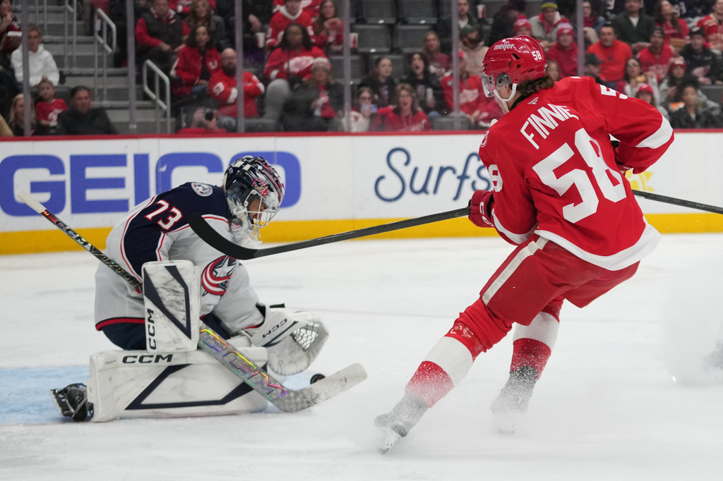 Columbus Blue Jackets goaltender Jet Greaves (73) stops a Detroit Red Wings center Emmitt Finnie (58) shot in the second period of an NHL hockey game Tuesday, April 7, 2026, in Detroit. (AP Photo/Paul Sancya)