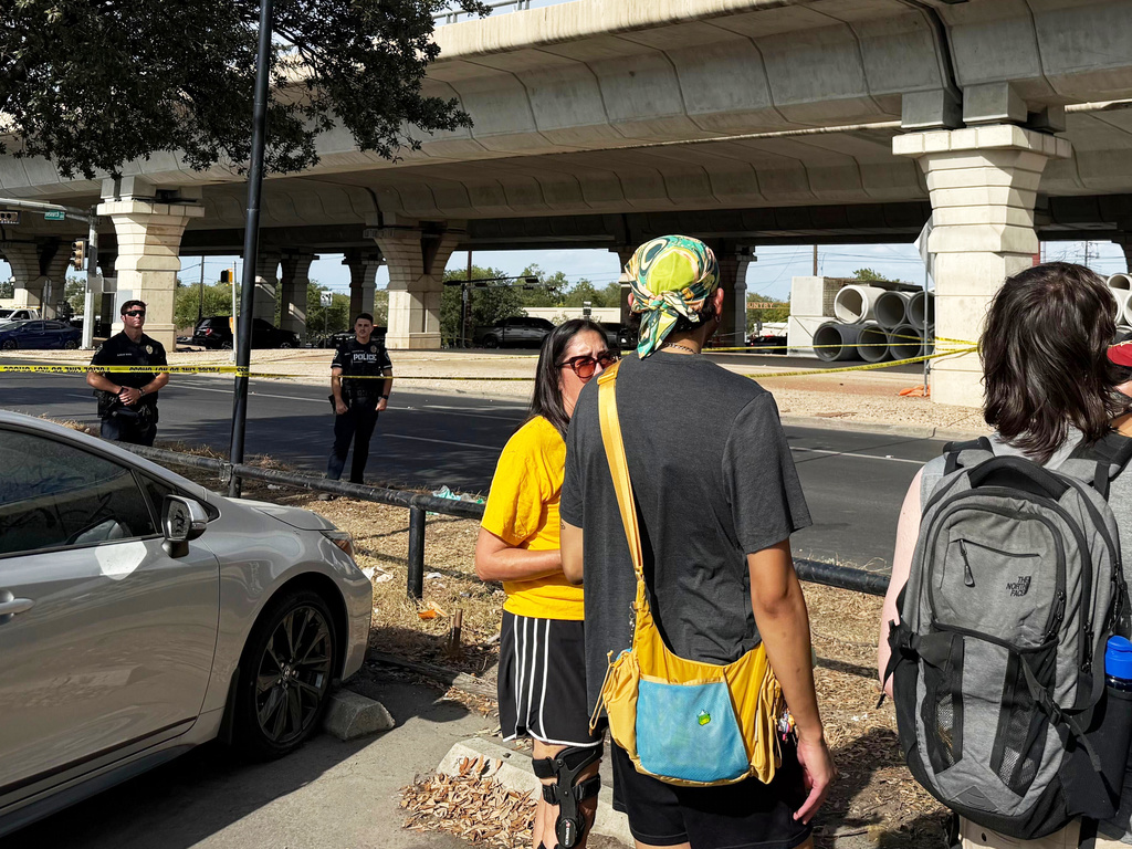 In this photo taken with a smart phone Police block a street after a shooting involving an ICE officer in Austin, Texas, Sunday, Sept. 20, 2026. (AP Photo/Jesse Bedayn)