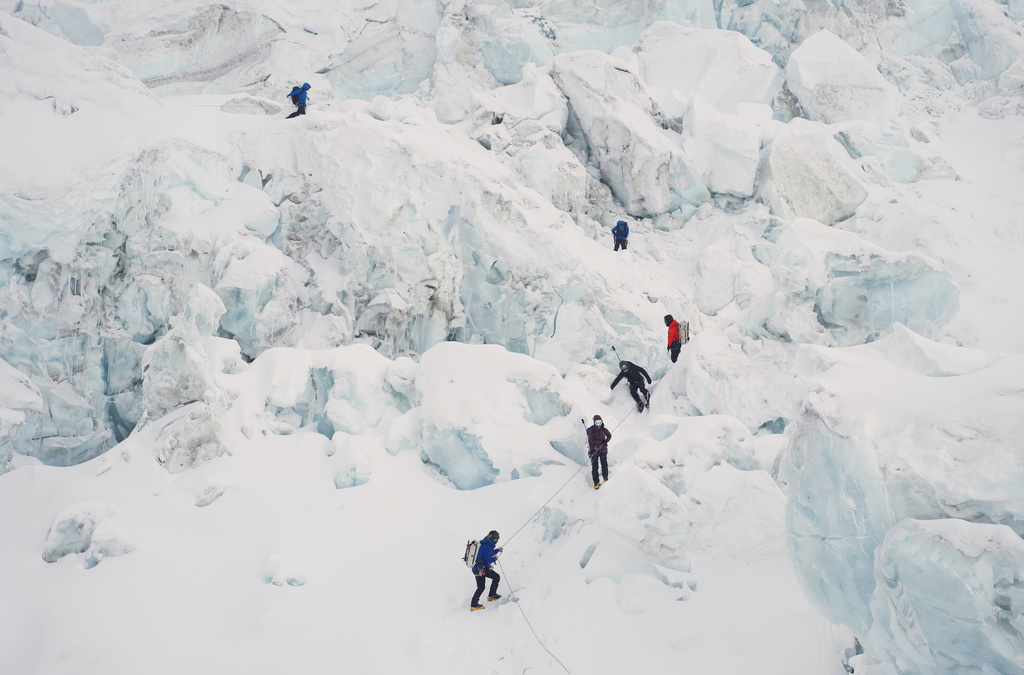 Mountaineers ascend Khumbu Icefall on their way to the summit of Mount Everest in Kathmandu, Nepal, Saturday, May 9, 2026. (AP Photo/Pasang Rinzee Sherpa)
