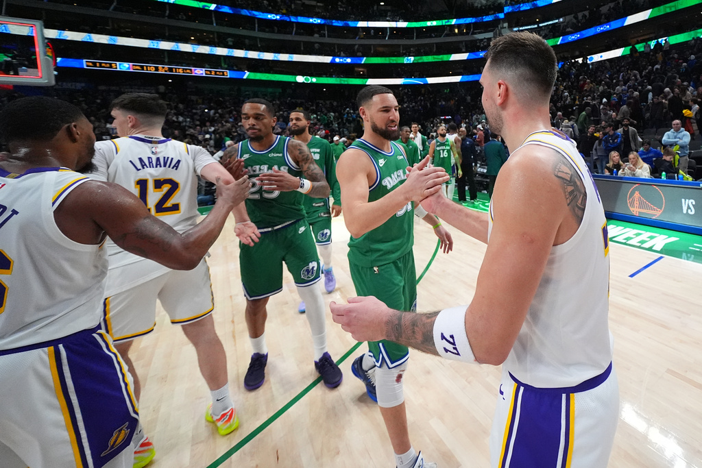 Los Angeles Lakers guard Luka Doncic, right, talks to Dallas Mavericks guard Klay Thompson following an NBA basketball game Saturday, Jan. 24, 2026, in Dallas. (AP Photo/Julio Cortez)