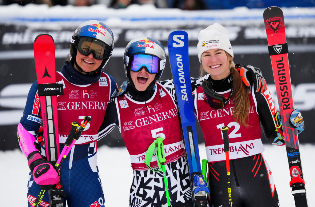 Alice Robinson, of New Zealand, middle, celebrates her first place finish with Zrinka Ljutic , of Croatia, left, who took second and Valerie Grenier, of Canada, who finished third in the women's World Cup giant slalom in Mont Tremblant, Quebec, Saturday, Dec. 6, 2025. (Sean Kilpatrick/The Canadian Press via AP)