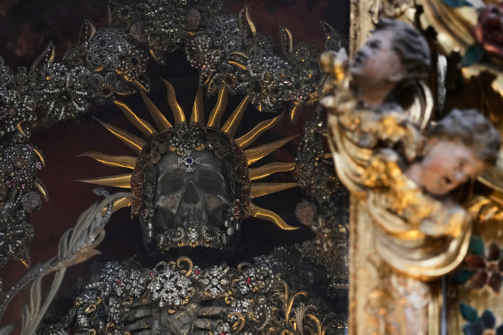 An elaborately decorated skeleton lies in the catholic monastery church of Banz in Bad Staffelstein, Germany, Saturday, May 2, 2026. (AP Photo/Matthias Schrader)