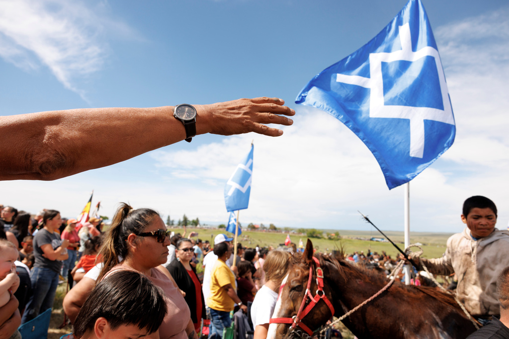 Riders and others gather after the horse charging event during festivities to commemorate the 150th anniversary of the Battle of the Little Bighorn in Crow Agency, Mont., on Thursday, June 25, 2026. (AP Photo/Tailyr Irvine)