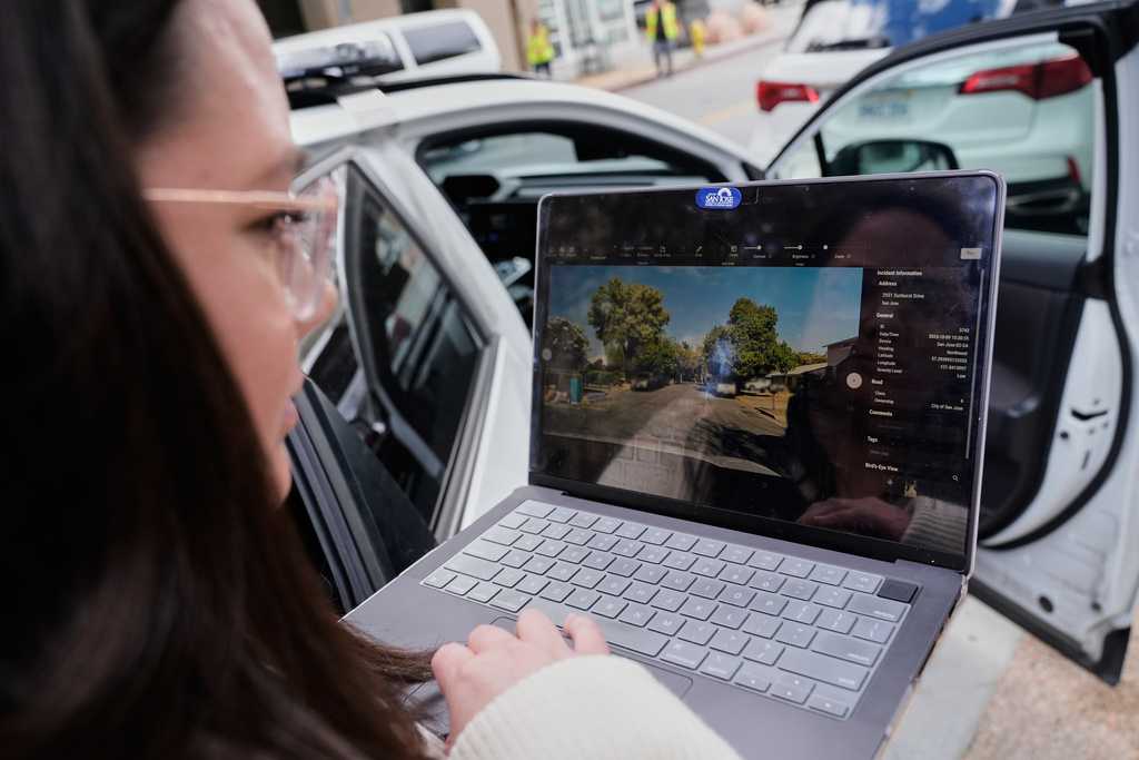Chelsea Palacio, public information manager for the City of San Jose, showcases how a small detection camera uses AI to detect road hazards and potholes, in San Jose, Calif., Wednesday, Nov. 12, 2025. (AP Photo/Godofredo A. Vásquez)
