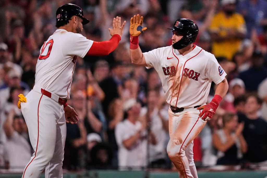 Boston Red Sox's Caleb Durbin, right, is congratulated by Willson Contreras after his two-run home run off New York Yankees' Cam Schlittler in the fifth inning of a baseball game, Thursday, June 25, 2026, in Boston. (AP Photo/Charles Krupa)