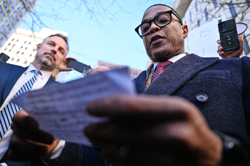 Journalist Don Lemon, right, speaks to the media outside the U.S. District Courthouse in St. Paul, Minn., Friday, Feb. 13, 2026. (AP Photo/Tom Baker)