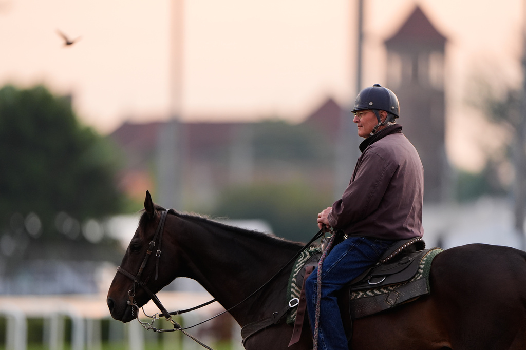 Trainer Bill Mott watches a workout at Churchill Downs Monday, April 27, 2026, in Louisville, Ky. (AP Photo/Charlie Riedel)