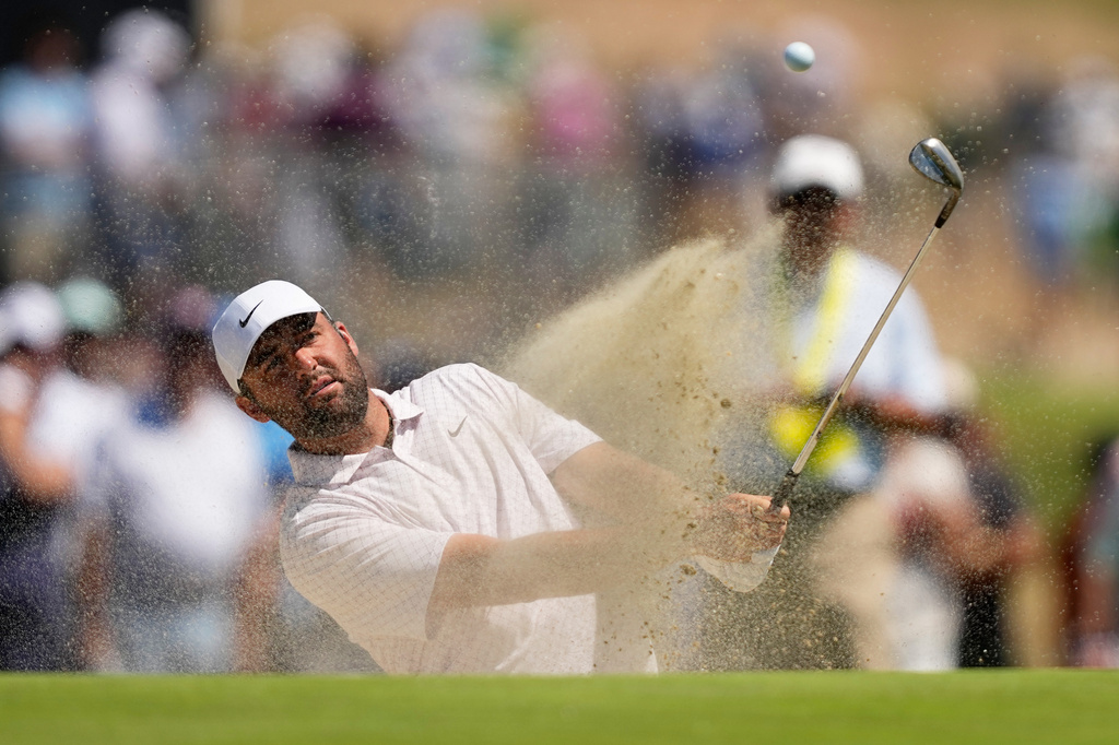 Scottie Scheffler hits from the bunker on the second hole during the third round of the U.S. Open golf tournament at Shinnecock Hills Golf Club in Southampton, N.Y., Saturday, June 20, 2026.(AP Photo/Gerald Herbert)