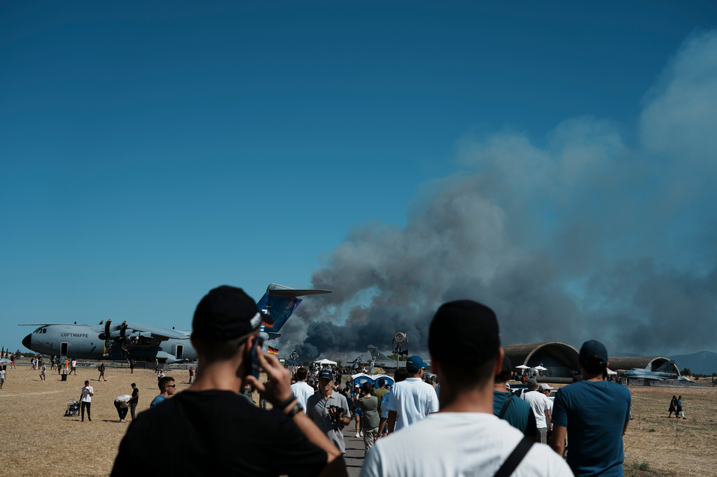 Spectators watch as smoke rises after a Hellenic Air Force F-4 Phantom fighter jet crashed, during the Athens Flying Week airshow at Tanagra Air Force Base, north of Athens, Greece, Saturday, Sept. 5, 2026. (AP Photo/Kallista Allaway)