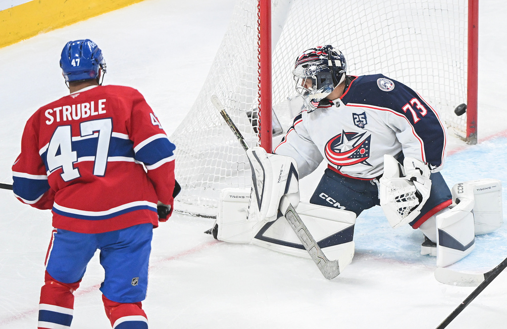 Montreal Canadiens' Jayden Struble (47) scores against Columbus Blue Jackets Jet Greaves (73) during first-period NHL hockey game action in Montreal, Thursday, March 26, 2026. (Graham Hughes/The Canadian Press via AP)