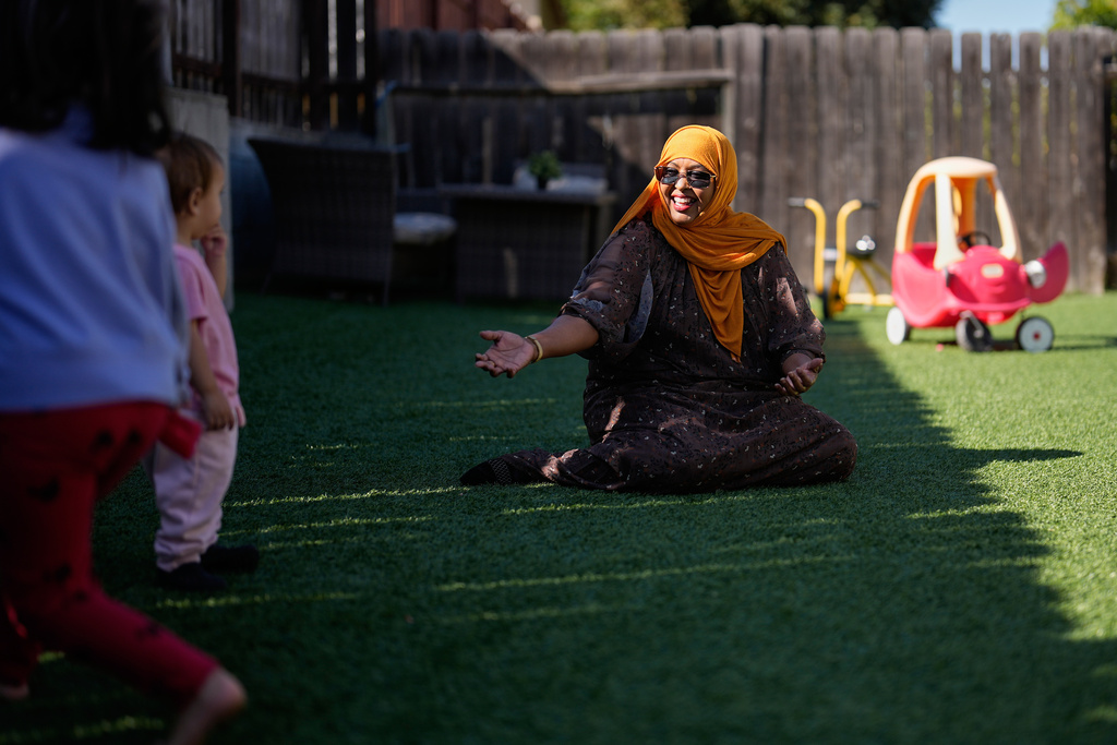 Samsam Khalif plays with children at her home-based child care center Friday, Jan. 30, 2026, in San Diego. (AP Photo/Gregory Bull)