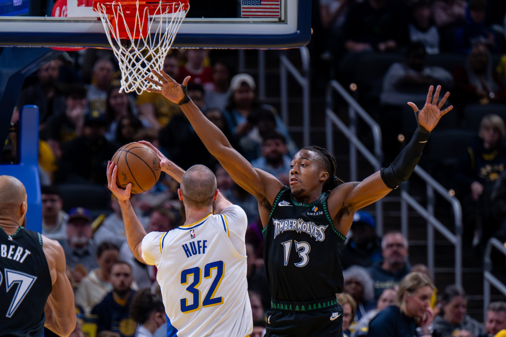 Minnesota Timberwolves guard Ayo Dosunmu (13) reaches for a shot attempt by Indiana Pacers center Jay Huff (32) during the first half of an NBA basketball game in Indianapolis, Tuesday, April 7, 2026. (AP Photo/Doug McSchooler)