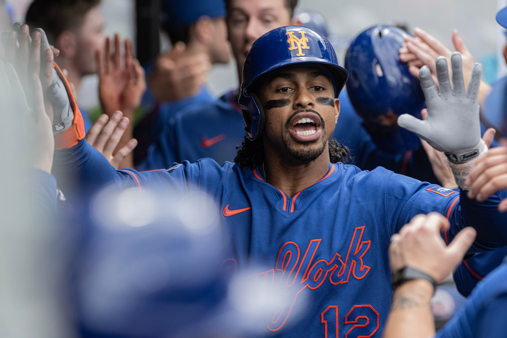 New York Mets' Francisco Lindor is congratulated by his teammates after hitting a three-run home run off Cleveland Guardians relief pitcher Craig Yoho during the seventh inning of a baseball game, Thursday, Aug. 6, 2026, in Cleveland. (AP Photo/Phil Long)