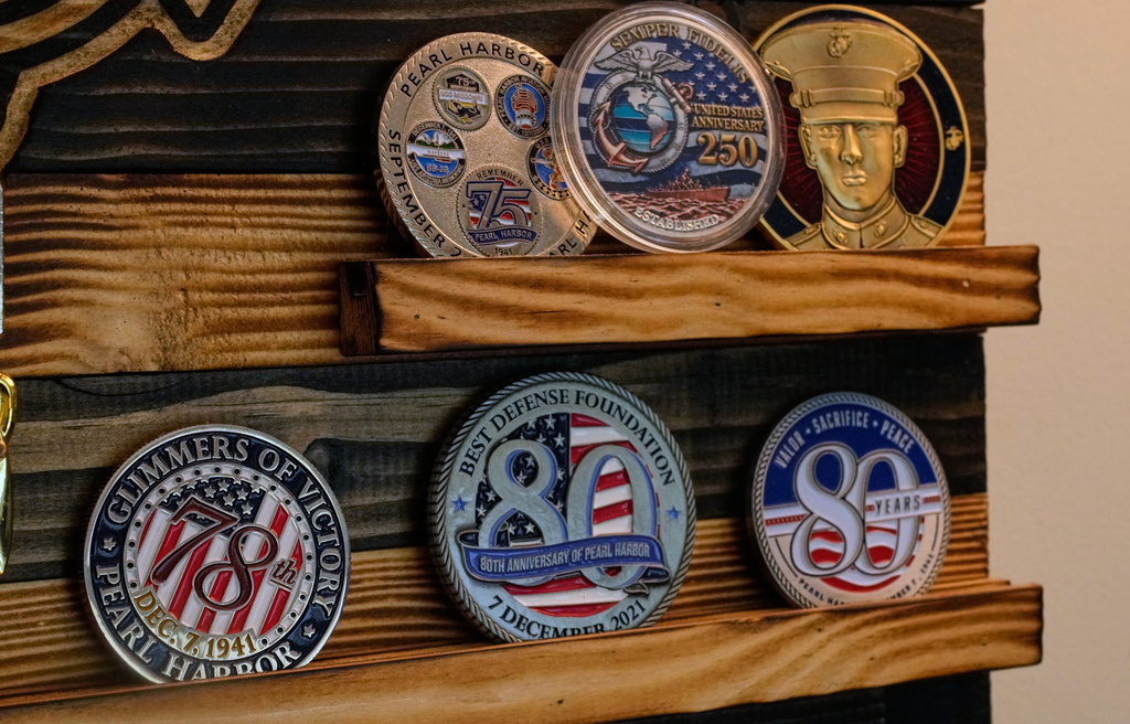 A collection of challenge coins is on display in Pearl Harbor survivor Freeman K. Johnson's home, May 6, 2026, in Centerville, Mass. (AP Photo/Charles Krupa)