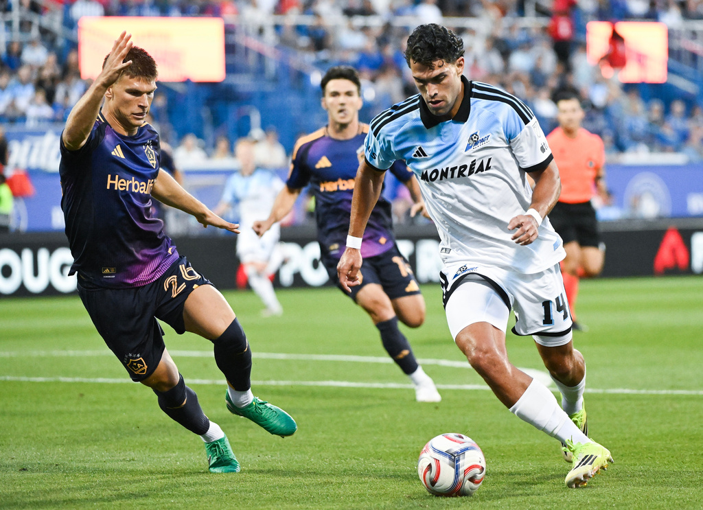 LA Galaxy's Harbor Miller (26) defends against CF Montreal's Daniel Rios (14) during the first half MLS soccer game in Montreal, Saturday, Aug. 22, 2026. (Graham Hughes/The Canadian Press via AP)