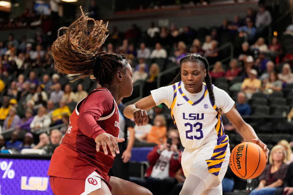 LSU guard Milaysia Fulwiley drives to the basket past Oklahoma forward Sahara Williams during second half of an NCAA college basketball game in the quarterfinals of the Southeastern Conference tournament, Friday, March 6, 2026, in Greenville, S.C. (AP Photo/Chris Carlson)