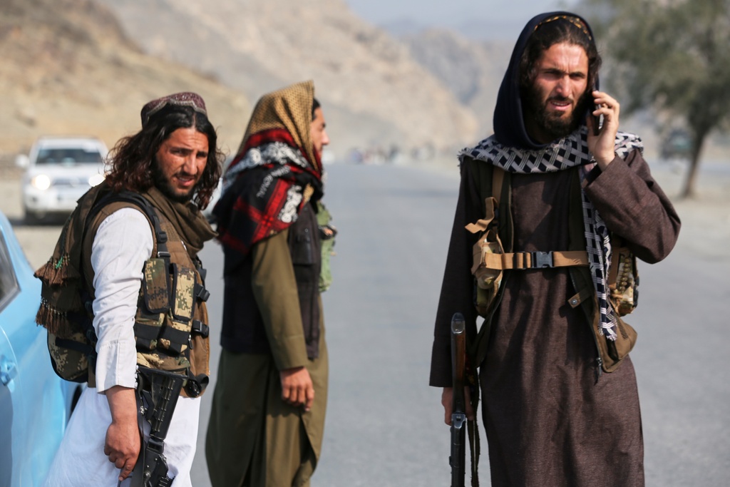 Afghan Taliban soldiers stand on the Afghan side of the Torkham border crossing with Pakistan in Torkham, Afghanistan, Friday, Feb. 27, 2026. (AP Photo/Wahidullah Kakar)