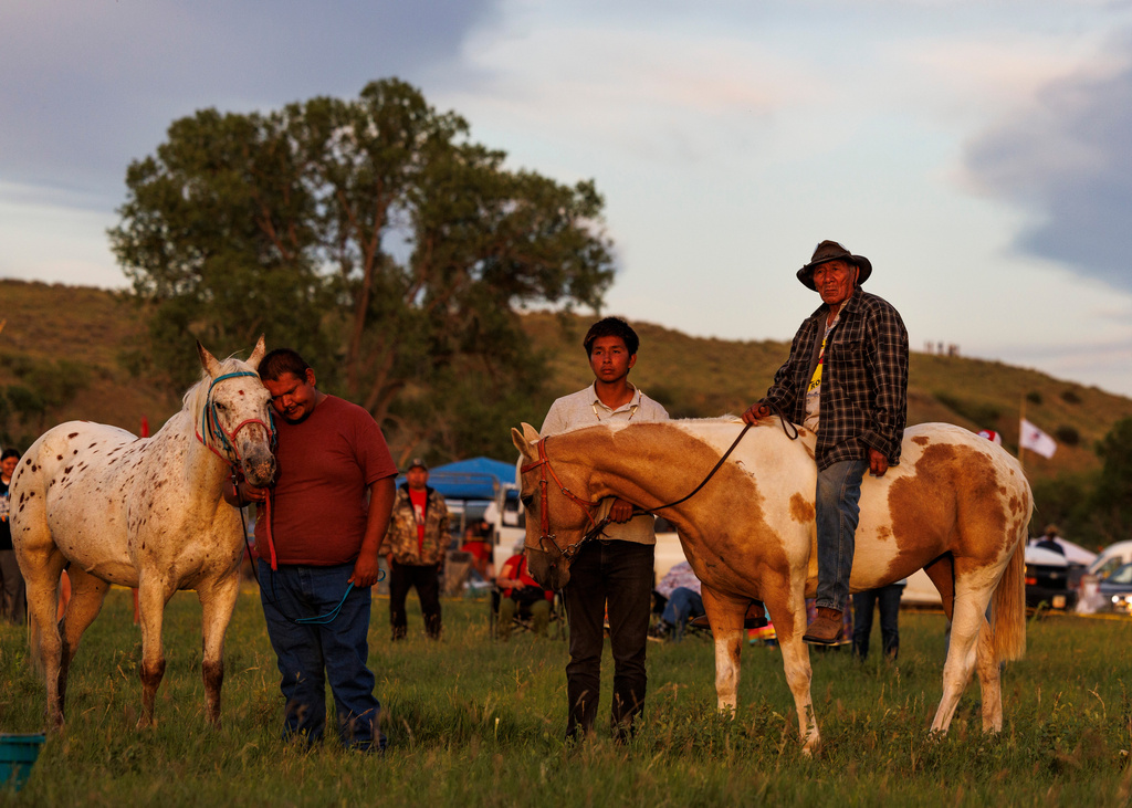 Riders wait for the horse ceremony to begin during festivities commemorating the 150th anniversary of the Battle of the Little Bighorn, Wednesday, June 24, 2026, in Crow Agency, Mont. (AP Photo/Tailyr Irvine)