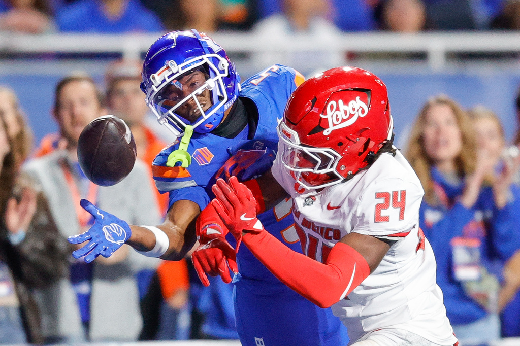 New Mexico cornerback Azariah Levells (24) knocks the ball way from Boise State wide receiver Chris Marshall (5) in the first half of an NCAA college football game, Saturday, Oct. 11, 2025, in Boise, Idaho. (AP Photo/Steve Conner)