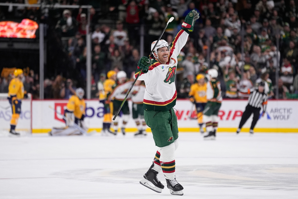 Minnesota Wild left wing Marcus Foligno (17) celebrates after the overtime win of an NHL hockey game against the Nashville Predators, Tuesday, Nov. 4, 2025, in St. Paul, Minn. (AP Photo/Abbie Parr)