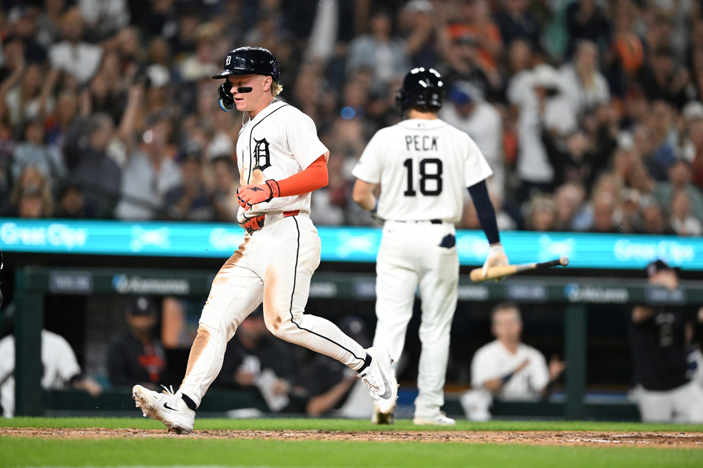 Detroit Tigers' Max Clark, left, scores a run on a wild pitch during the sixth inning of a baseball game against the Colorado Rockies, Friday, Sept. 11, 2026, in Detroit. (AP Photo/Jose Juarez)