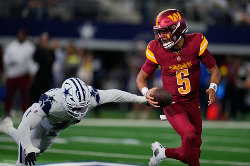 Washington Commanders quarterback Jayden Daniels (5) avoids a tackle by Dallas Cowboys defensive end Donovan Ezeiruaku during the first half of an NFL football game Sunday, Oct. 19, 2025, in Arlington, Texas. (AP Photo/Jeffrey McWhorter) Washington Commanders quarterback Jayden Daniels (5) avoids a tackle by Dallas Cowboys defensive end Donovan Ezeiruaku during the first half of an NFL football game Sunday, Oct. 19, 2025, in Arlington, Texas. (AP Photo/Jeffrey McWhorter)