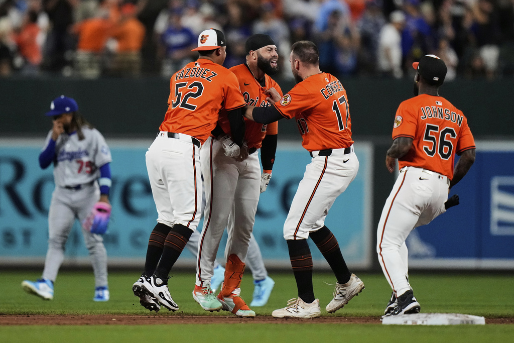 Baltimore Orioles' Emmanuel Rivera, second from left, celebrates with teammates after hitting a walk-off single during the ninth inning of a baseball game against the Los Angeles Dodgers, Saturday, Sept. 6, 2025, in Baltimore. (AP Photo/Stephanie Scarbrough)
