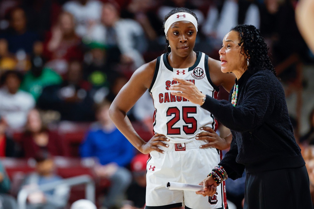 South Carolina head coach Dawn Staley, right, talks to guard Raven Johnson (25) during the first half of an NCAA college basketball game against Grand Canyon in Columbia, S.C., Monday, Nov. 3, 2025. (AP Photo/Nell Redmond)