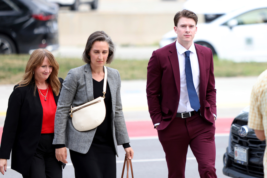 FILE - Hockey player Carter Hart, right, arrives at the London Courthouse in London, Ontario, Thursday, July 24, 2025. (Nicole Osborne/The Canadian Press via AP, File)
